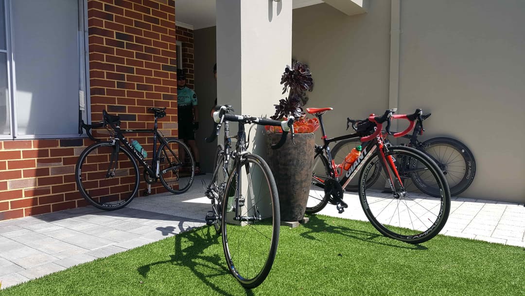 Photograph of road bikes parked in front of house