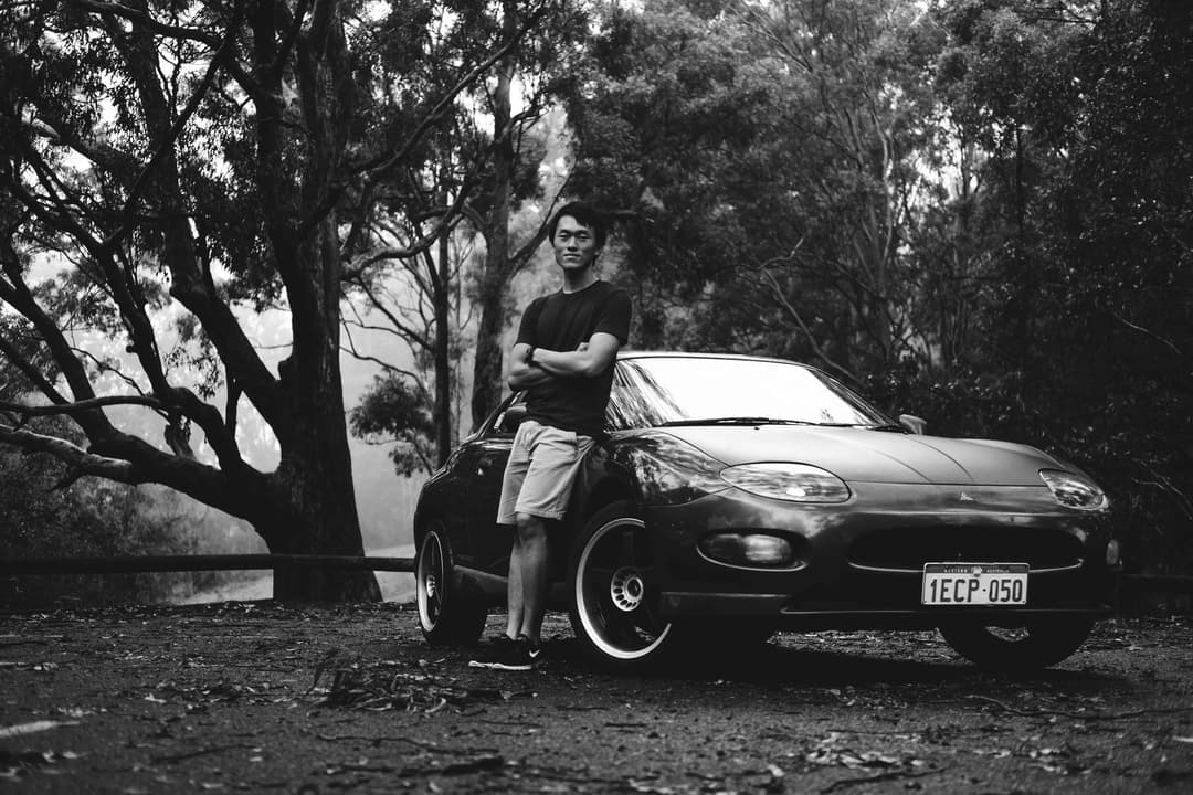 Photograph of man standing in front of a Mitsubishi FTO
