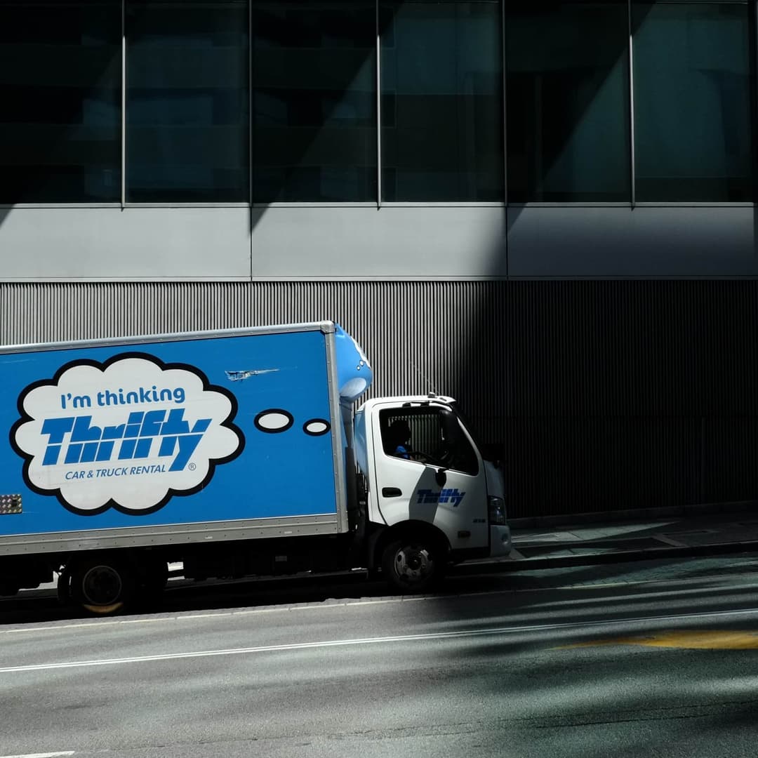 Landscape photo of a Thrifty rental truck parked by side of the road